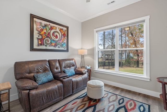 living room featuring crown molding, ceiling fan, and hardwood / wood-style flooring