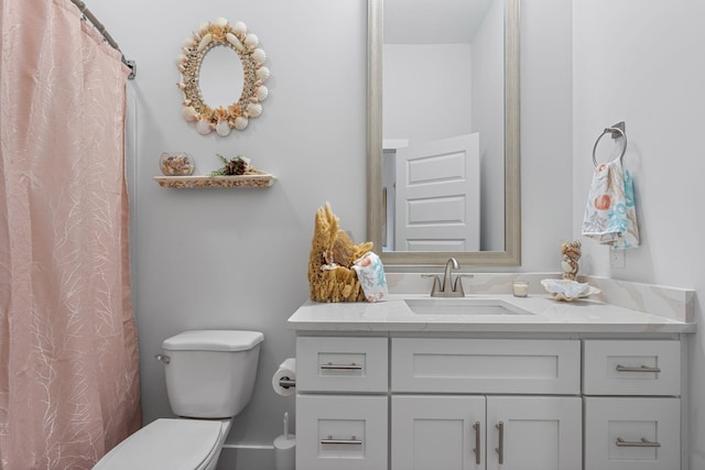 bathroom featuring vanity and toilet