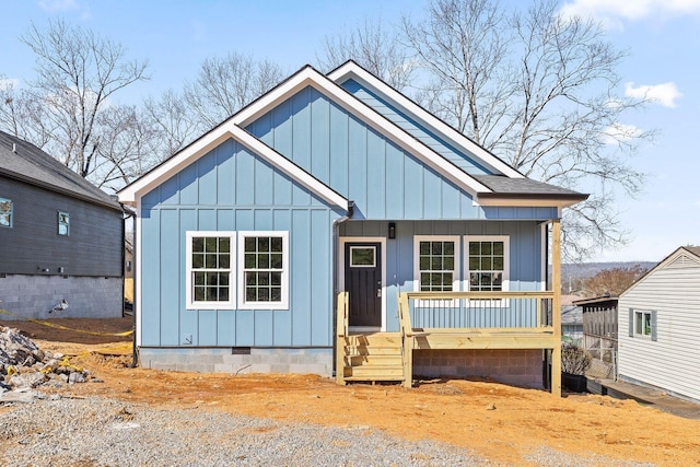 view of front of home with crawl space, board and batten siding, and roof with shingles