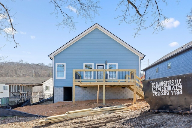 rear view of house with a wooden deck