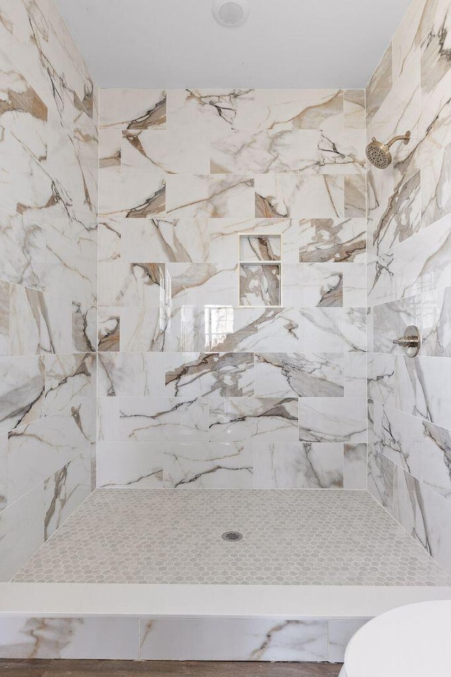 full bathroom with toilet and tiled shower