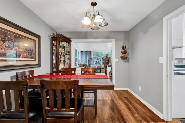 dining area featuring a notable chandelier and dark hardwood / wood-style floors