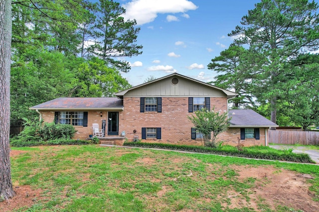 split level home featuring a front lawn