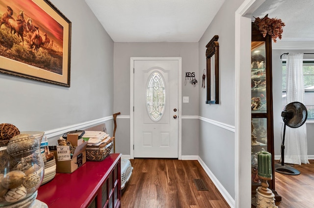 foyer entrance featuring dark hardwood / wood-style floors and a textured ceiling