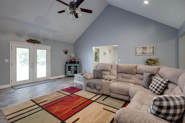 living room featuring ceiling fan, french doors, high vaulted ceiling, and light hardwood / wood-style floors