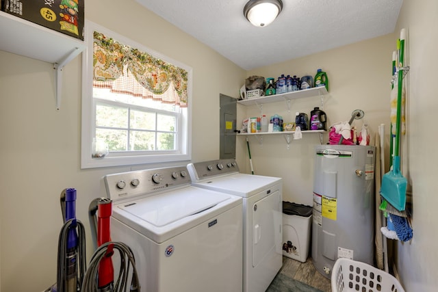 washroom featuring light hardwood / wood-style floors, separate washer and dryer, a textured ceiling, and water heater