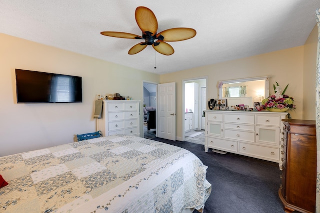 bedroom with ceiling fan, ensuite bathroom, a textured ceiling, and dark colored carpet