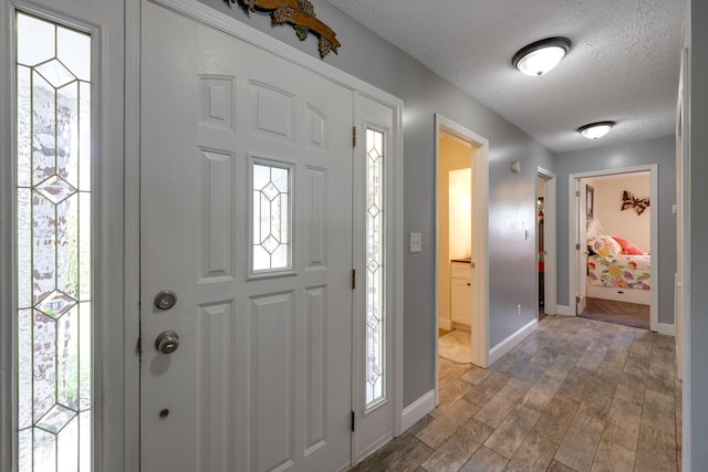 entrance foyer featuring hardwood / wood-style floors and a textured ceiling