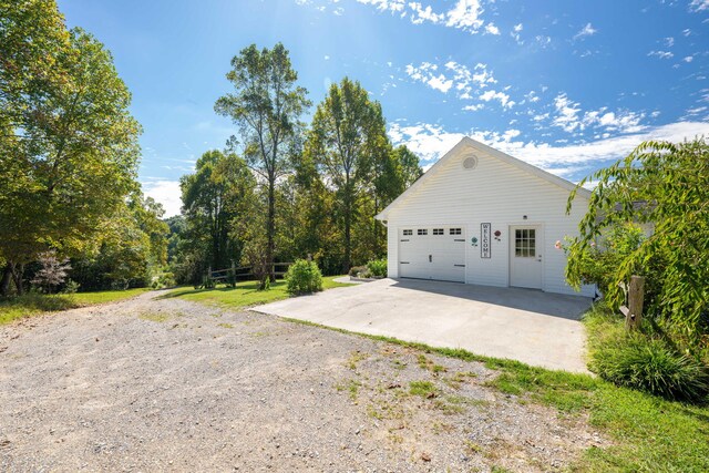 view of property exterior featuring a garage and an outbuilding