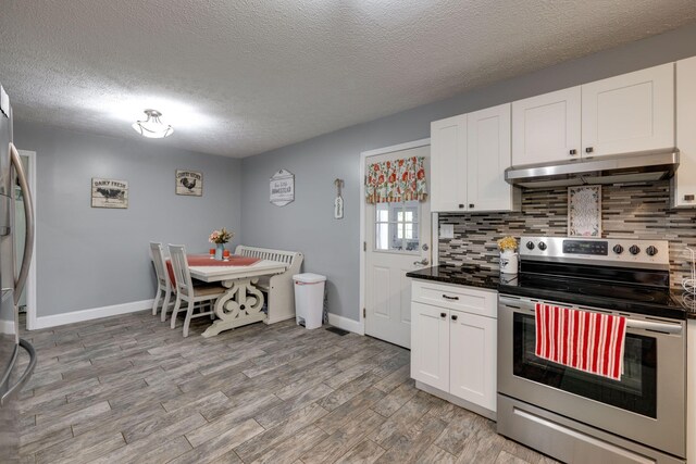 kitchen with backsplash, white cabinetry, stainless steel appliances, and light hardwood / wood-style flooring