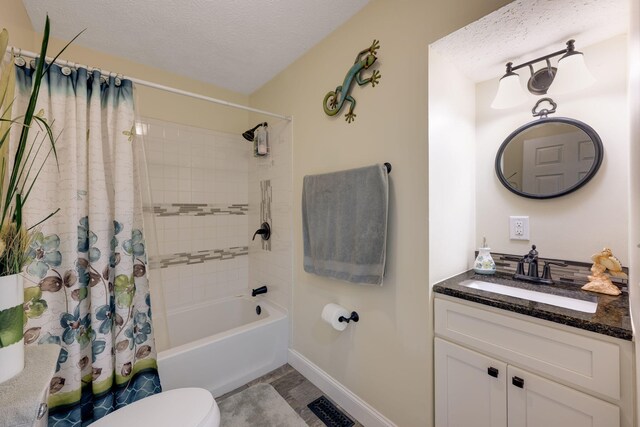 full bathroom with a textured ceiling, vanity, shower / bath combo, and toilet