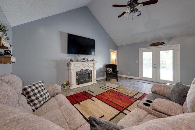 living room featuring french doors, hardwood / wood-style flooring, high vaulted ceiling, and ceiling fan