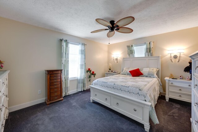 carpeted bedroom featuring a textured ceiling, multiple windows, and ceiling fan