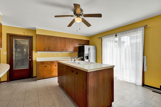 2408 Peerless Rd NW, Cleveland, TN 37311 - kitchen with brown cabinets, a ceiling fan, a sink, stainless steel fridge with ice dispenser, and light countertops
