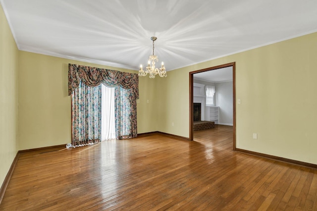 2408 Peerless Rd NW, Cleveland, TN 37311 - unfurnished room featuring plenty of natural light, a notable chandelier, crown molding, and hardwood / wood-style flooring