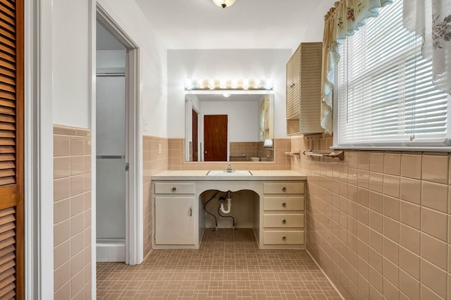 2408 Peerless Rd NW, Cleveland, TN 37311 - bathroom with vanity, tile walls, a shower stall, and wainscoting