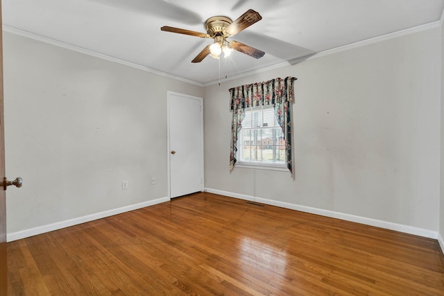 2408 Peerless Rd NW, Cleveland, TN 37311 - spare room featuring wood finished floors, visible vents, baseboards, ceiling fan, and crown molding