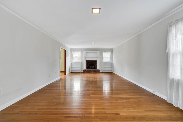 2408 Peerless Rd NW, Cleveland, TN 37311 - unfurnished living room featuring a fireplace, crown molding, wood finished floors, and baseboards
