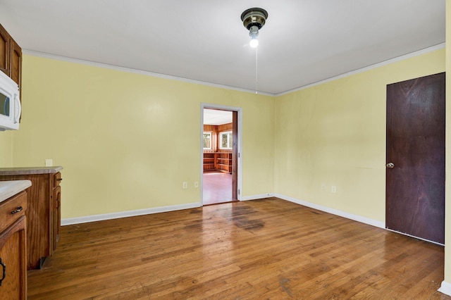 2408 Peerless Rd NW, Cleveland, TN 37311 - empty room featuring dark wood-style floors, baseboards, and ornamental molding