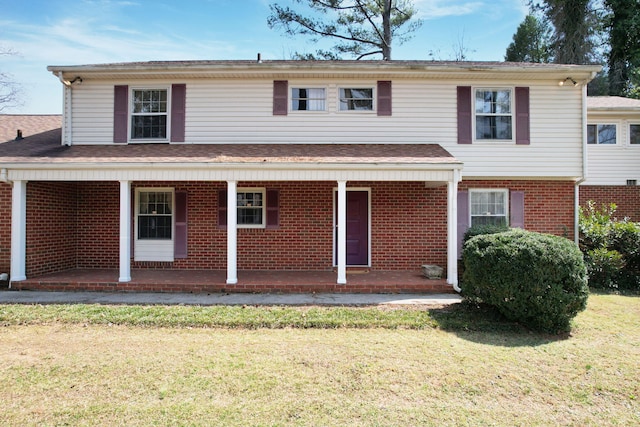 2408 Peerless Rd NW, Cleveland, TN 37311 - traditional-style home featuring brick siding, a porch, and a front yard