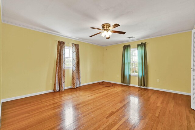 2408 Peerless Rd NW, Cleveland, TN 37311 - spare room featuring hardwood / wood-style flooring, ornamental molding, a wealth of natural light, and ceiling fan