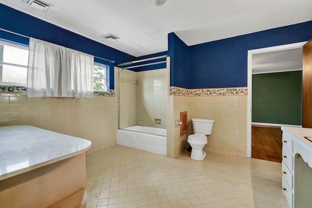 2408 Peerless Rd NW, Cleveland, TN 37311 - full bathroom featuring visible vents, toilet, tile walls, and shower / bathtub combination