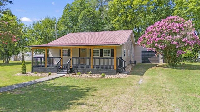 view of front facade with covered porch, a garage, and a front lawn