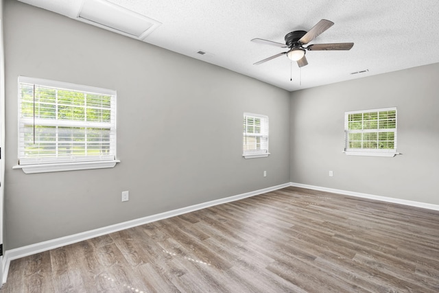 unfurnished room with ceiling fan, a textured ceiling, and hardwood / wood-style flooring