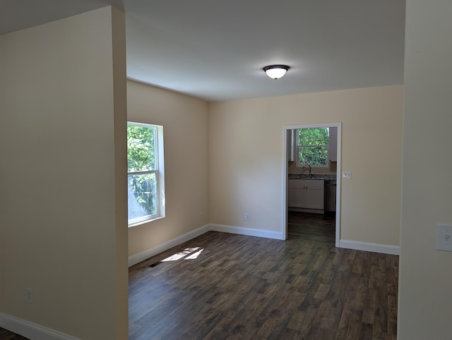 2811 E 26th St, Chattanooga, TN 37407 - spare room with healthy amount of natural light, dark wood finished floors, baseboards, and a sink