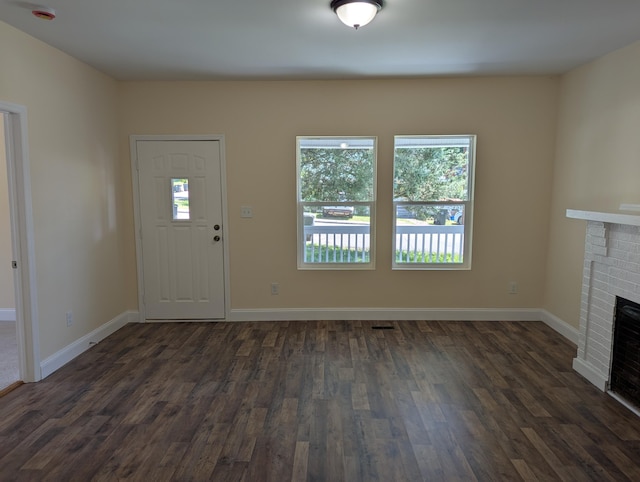 2811 E 26th St, Chattanooga, TN 37407 - unfurnished living room with dark wood-style flooring, baseboards, and a fireplace