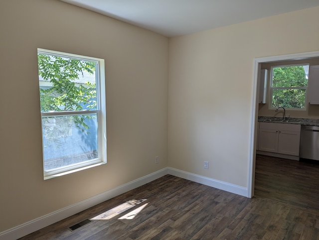 2811 E 26th St, Chattanooga, TN 37407 - spare room with plenty of natural light, dark wood-type flooring, baseboards, and a sink