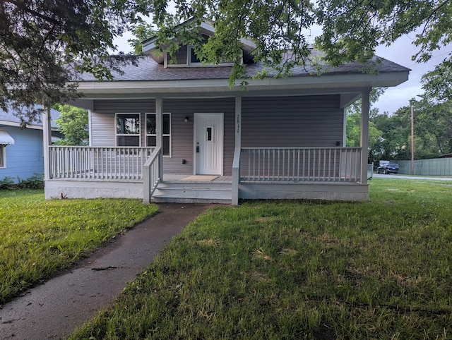 2811 E 26th St, Chattanooga, TN 37407 - bungalow-style house featuring roof with shingles, covered porch, and a front yard