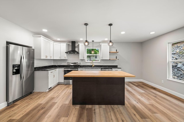 1523 Eads Bluff Rd NW, Georgetown, TN 37336 - kitchen with appliances with stainless steel finishes, wall chimney exhaust hood, butcher block counters, backsplash, and white cabinets