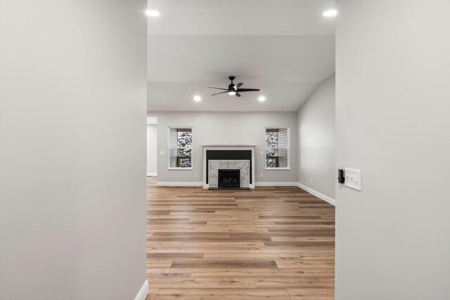 1523 Eads Bluff Rd NW, Georgetown, TN 37336 - unfurnished living room featuring recessed lighting, baseboards, light wood-type flooring, a ceiling fan, and a high end fireplace