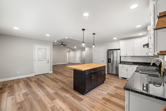 1523 Eads Bluff Rd NW, Georgetown, TN 37336 - kitchen with stainless steel fridge, wooden counters, a center island, under cabinet range hood, and white cabinets
