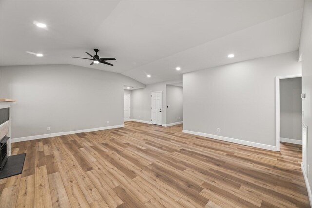 1523 Eads Bluff Rd NW, Georgetown, TN 37336 - unfurnished living room featuring a tiled fireplace, a ceiling fan, recessed lighting, light wood-type flooring, and vaulted ceiling