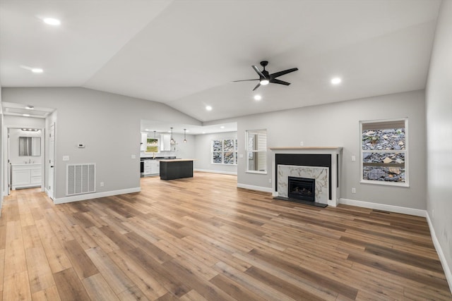 1523 Eads Bluff Rd NW, Georgetown, TN 37336 - unfurnished living room with a ceiling fan, light wood-style flooring, lofted ceiling, a high end fireplace, and recessed lighting