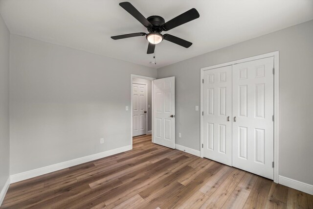 1523 Eads Bluff Rd NW, Georgetown, TN 37336 - unfurnished bedroom featuring baseboards, wood finished floors, a closet, and a ceiling fan