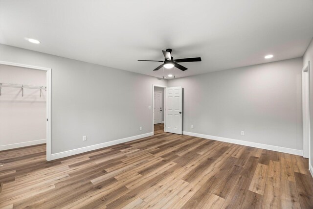 1523 Eads Bluff Rd NW, Georgetown, TN 37336 - unfurnished bedroom featuring recessed lighting, baseboards, wood finished floors, ceiling fan, and a walk in closet