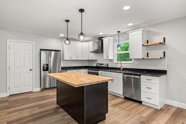 1523 Eads Bluff Rd NW, Georgetown, TN 37336 - kitchen featuring appliances with stainless steel finishes, wooden counters, wall chimney range hood, decorative backsplash, and light wood-style flooring