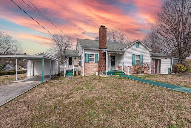 view of front of home with a shingled roof, a front yard, a chimney, stone siding, and driveway