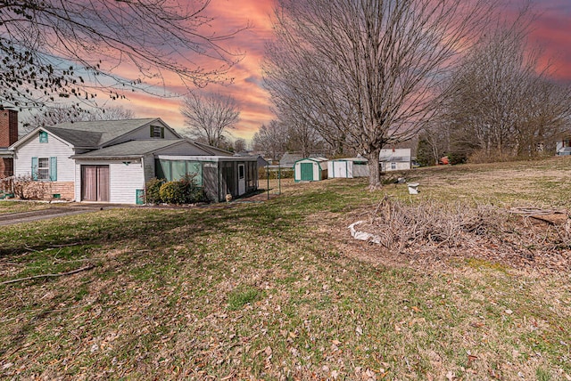 view of yard featuring an outbuilding and a storage shed