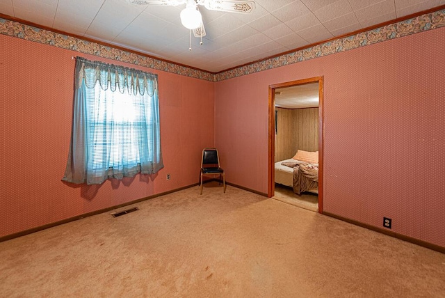 unfurnished bedroom featuring visible vents, ceiling fan, baseboards, and carpet floors