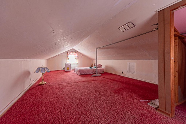 additional living space with lofted ceiling and carpet flooring