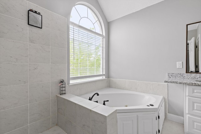 1905 Igou Crossing Dr, Chattanooga, TN 37421 - bathroom with vaulted ceiling, a whirlpool tub, plenty of natural light, vanity, and tile patterned flooring