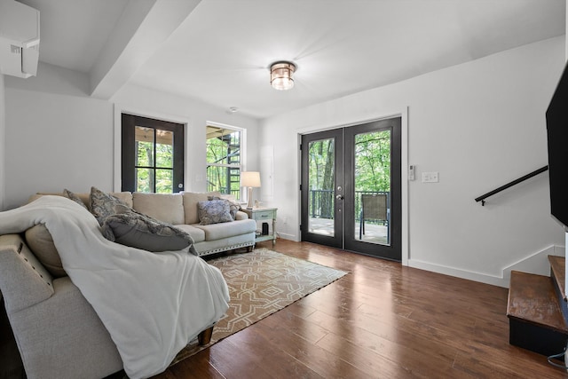 living area featuring french doors, stairs, baseboards, and wood finished floors