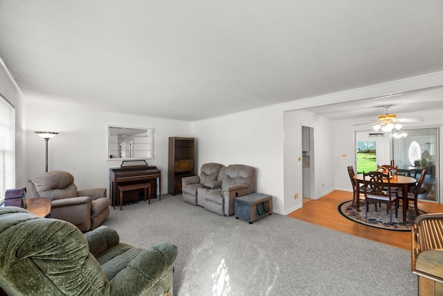 living room with ceiling fan and light hardwood / wood-style flooring