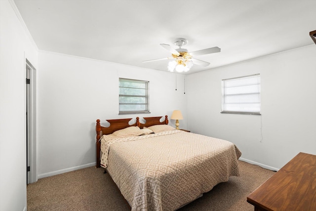 carpeted bedroom featuring multiple windows, ornamental molding, and ceiling fan