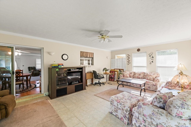 living room with ceiling fan, light wood-type flooring, a textured ceiling, and ornamental molding