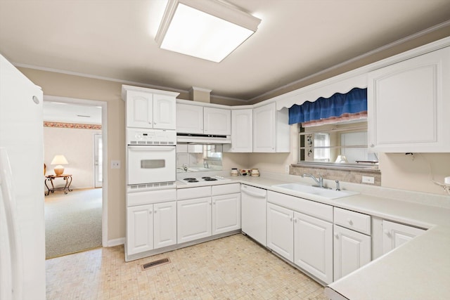 kitchen featuring crown molding, sink, white cabinets, and white appliances